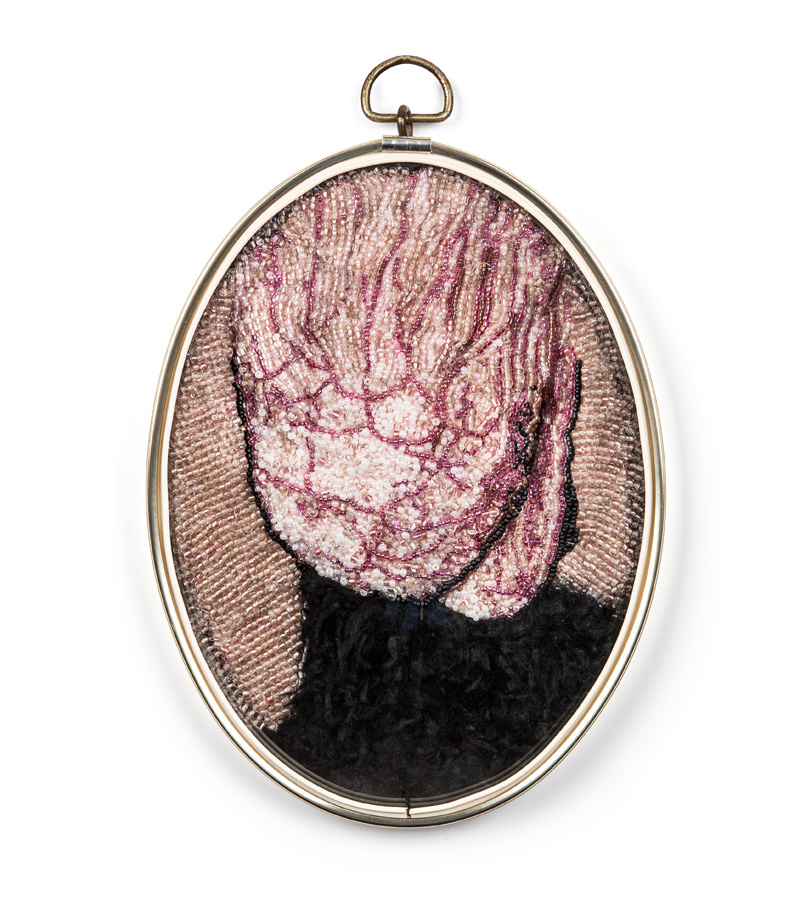 Trophy (2018), 20x17x4cm. Beads, fake fur, glass, frame.